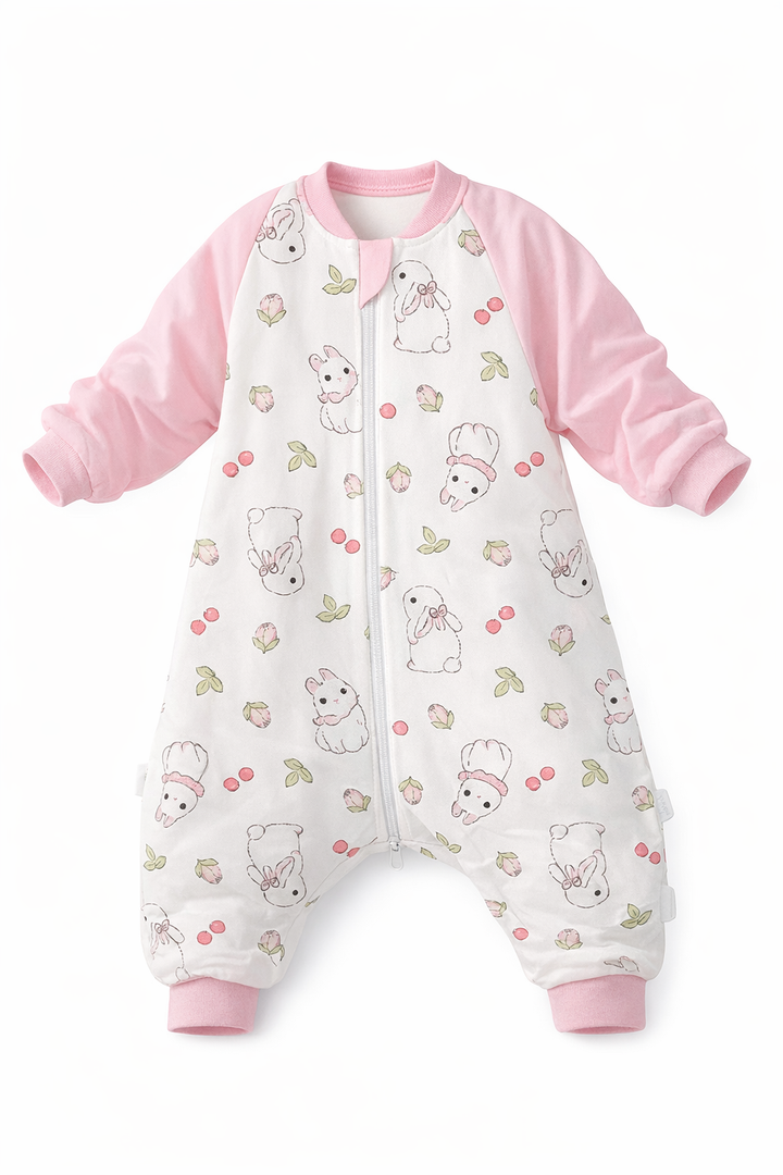 Toddler walking in a 1.5 TOG sleeping bag with rabbit print.